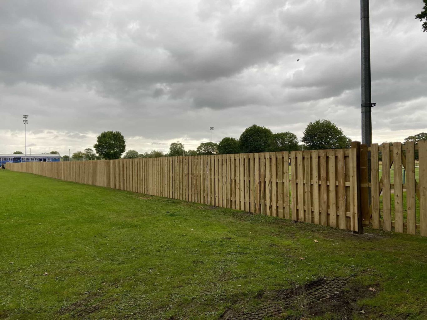 Fencing at amesbury football club completed looking down the football pitch.