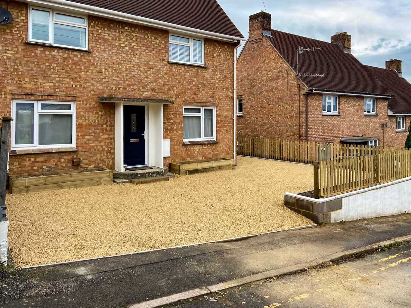 Gravel driveway completed at the front of a house.