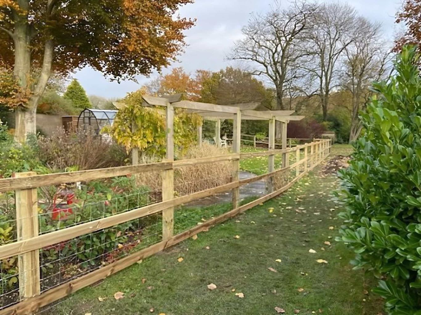 Horizontal fencing being installed across vertical fence posts.