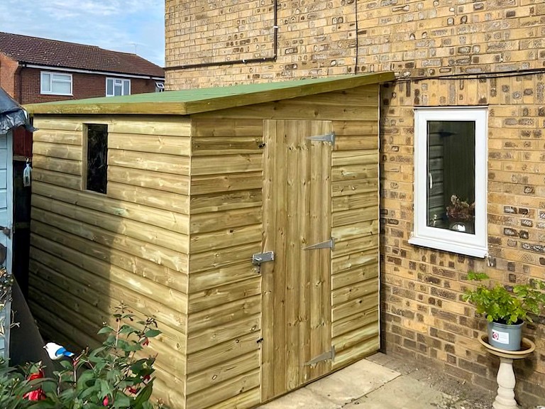 Medium sized garden shed with pent roof.
