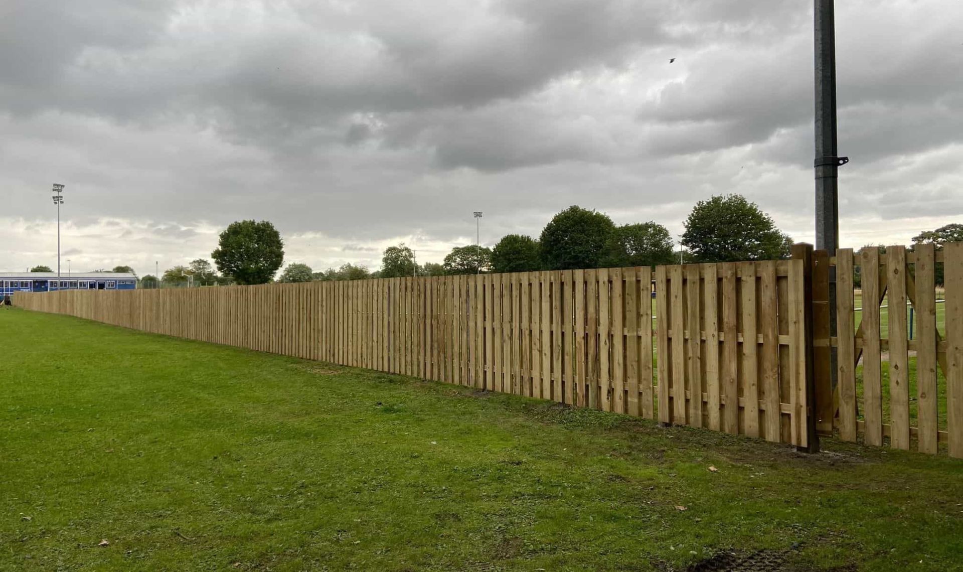 Fencing at amesbury football club completed looking down the football pitch.