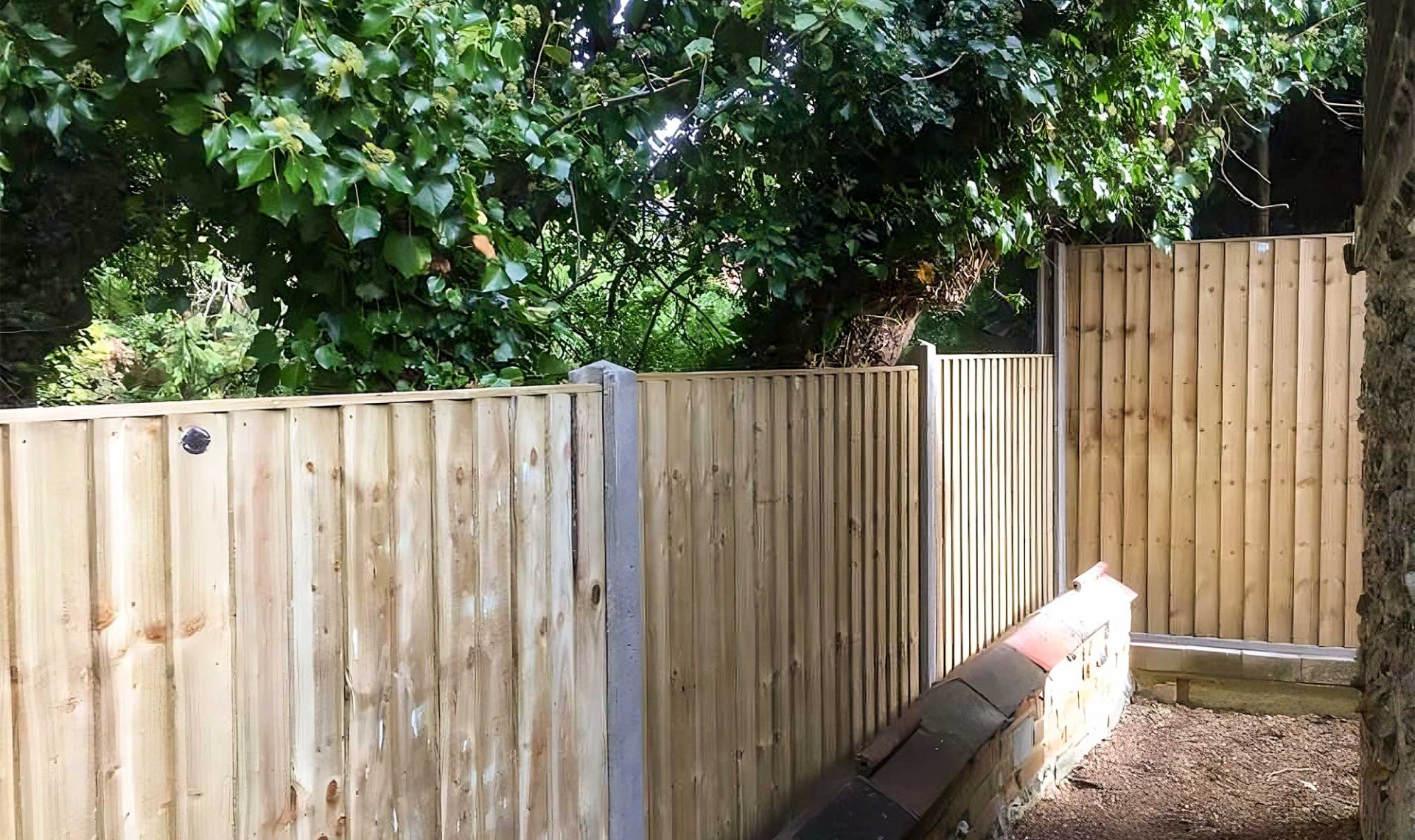 Panel fencing running through garden and along bottom.
