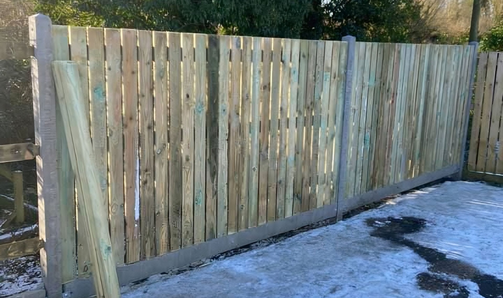 Vertical fence panels installed, close up.