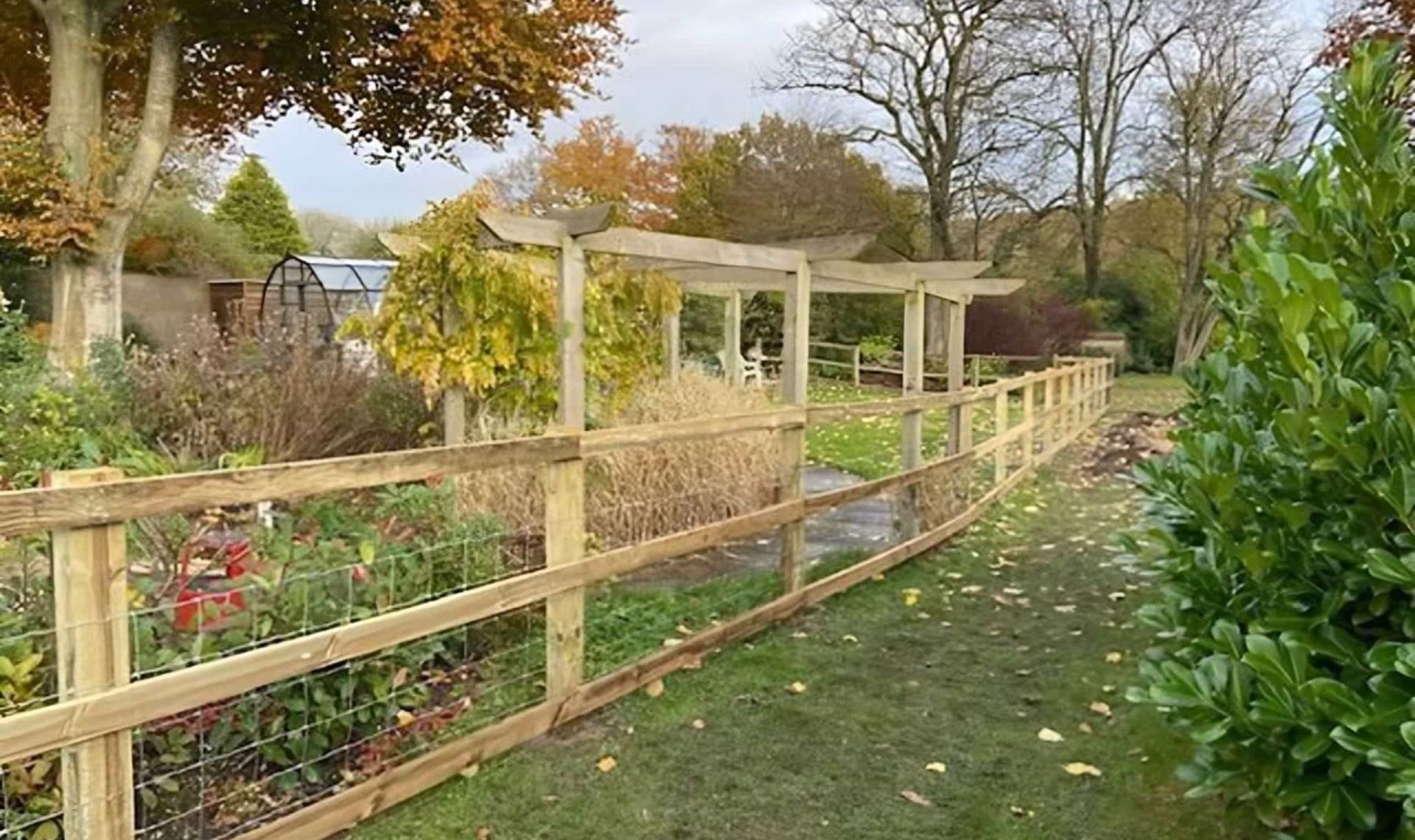 Horizontal fencing being installed across vertical fence posts.